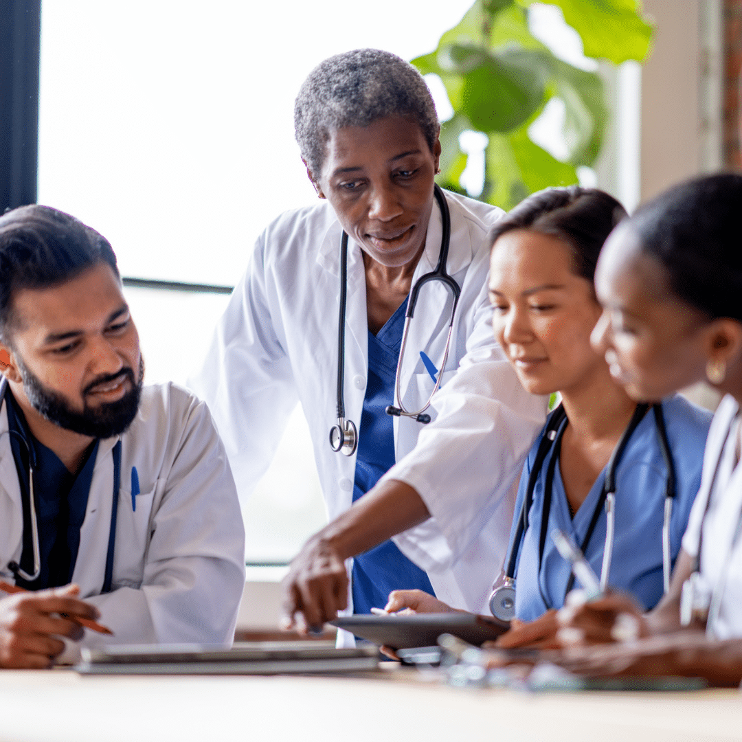 four doctors discussing advanced analytics